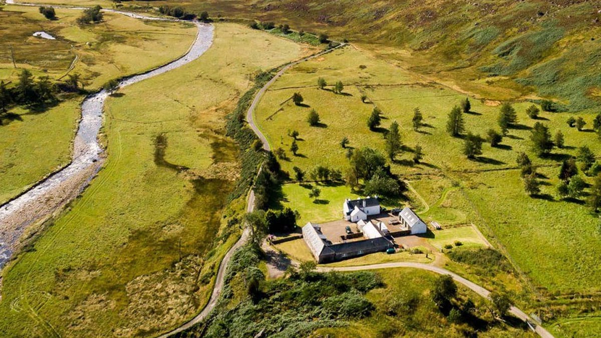 A farmhouse beside a river in a quiet Angus glen